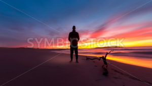 Man on Beach at Sunset - Symbiostock Express Demo